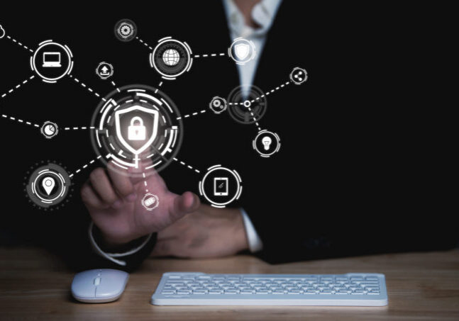 Businessman touch virtual screen on computer,Cyber secutiry concept,A shield protects the laptop from virus from the internet.